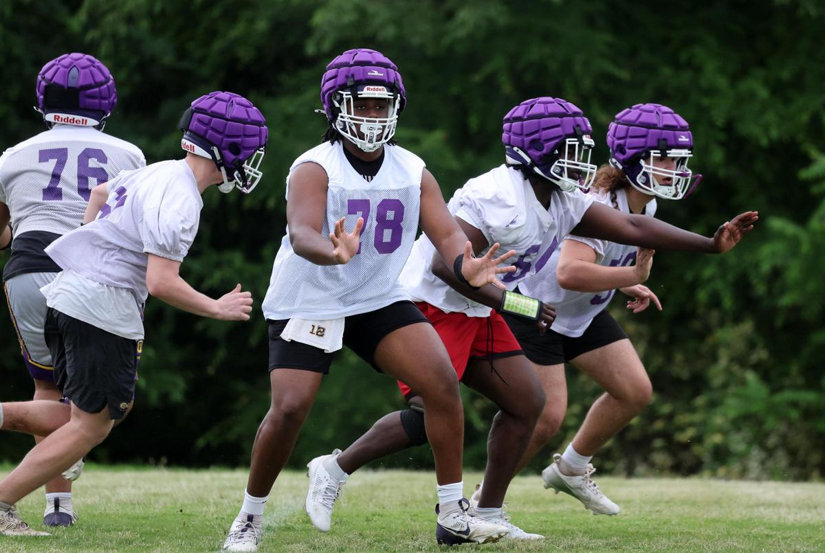 Northwestern High School varsity football players practice after school on Thursday.