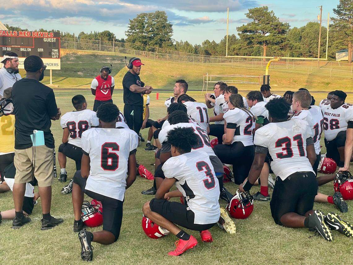 DeMarcus Simons, second year head coach at Great Falls, talks to his team after a scrimmage with Buford in August 2021.