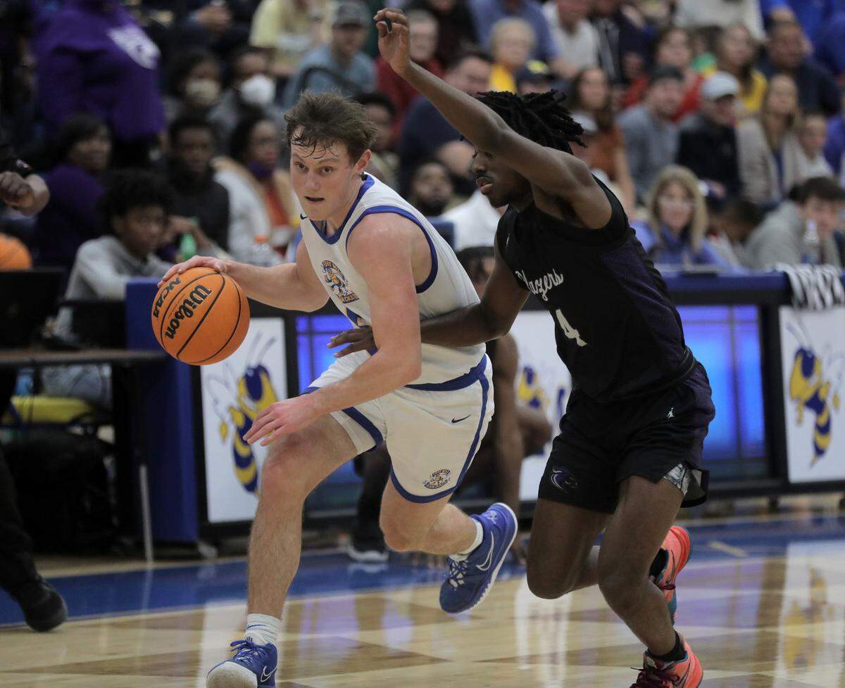 Fort Mill’s Kyle Neibch heads up the court alongside Ridgeview’s Nick Letthand Monday as the Yellow Jackets take on the Blazers in Fort Mill.