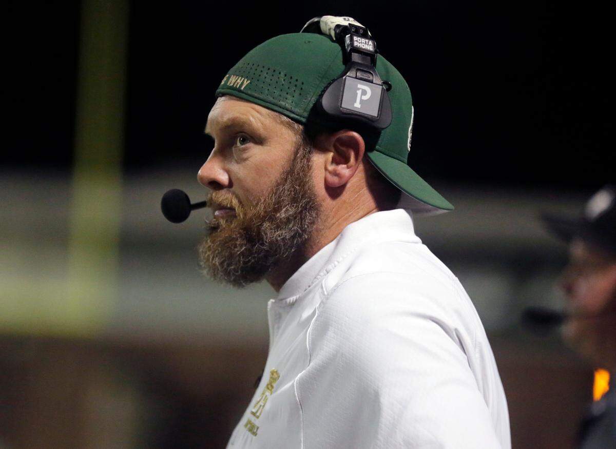 Catawba Ridge High School varsity football coach looks at the scoreboard Friday, Aug. 18, 2023.