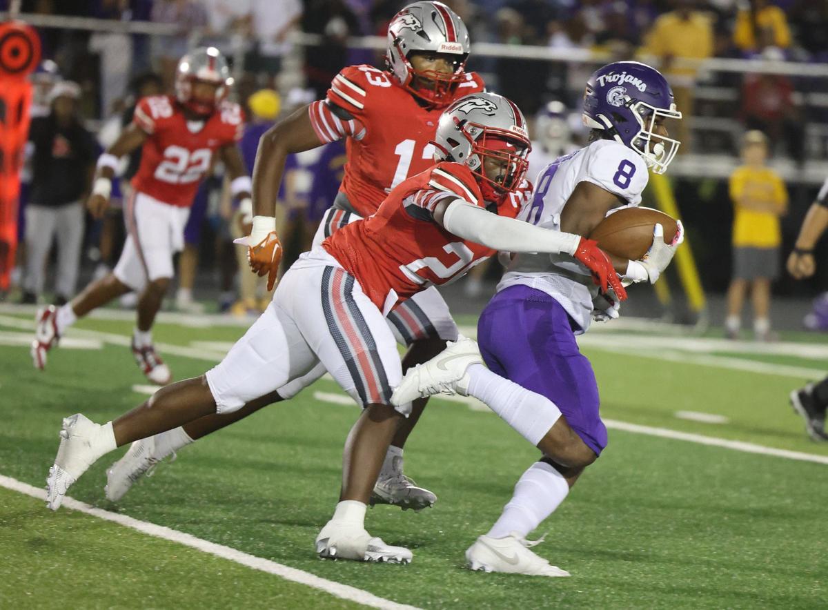 Northwestern’s Zymier Gordon-Miles (8) is tackled by South Pointe’s Dequan Evans Friday as the Trojans and Stallions compete in Rock Hill.