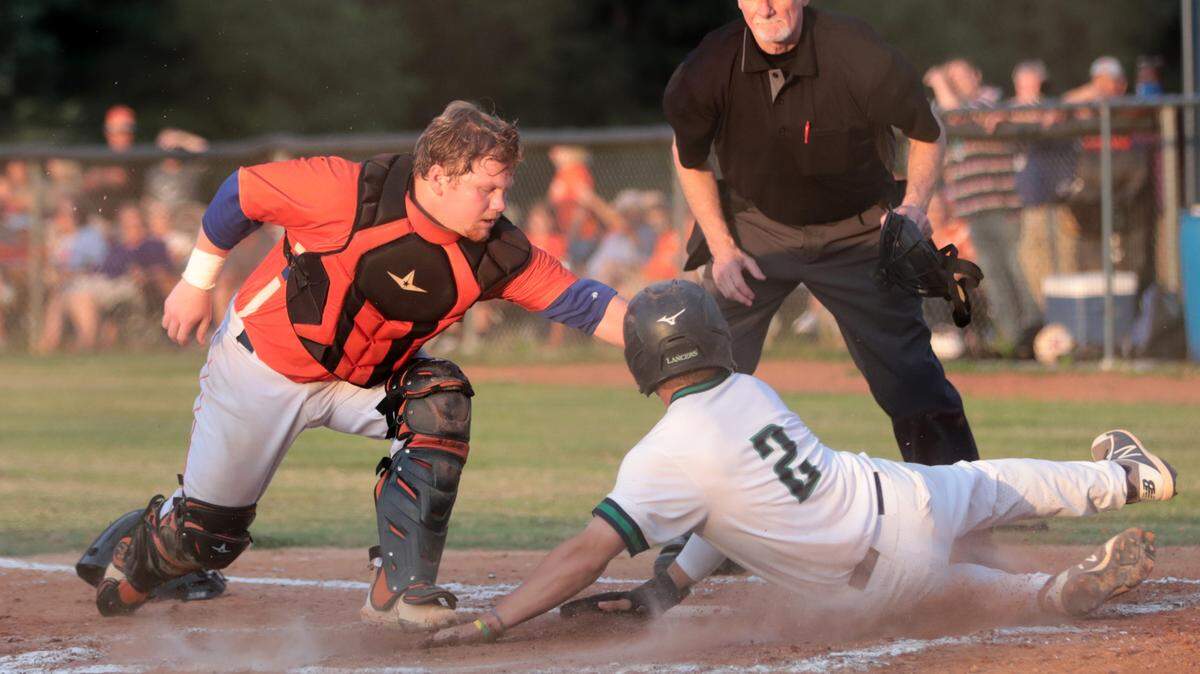Herald file: Andrew Jackson catcher Gavin Phillips tries to tag a Legion baserunner out in the 2021 state championship series. The Volunteers hope to make another run to the state title in 2022.