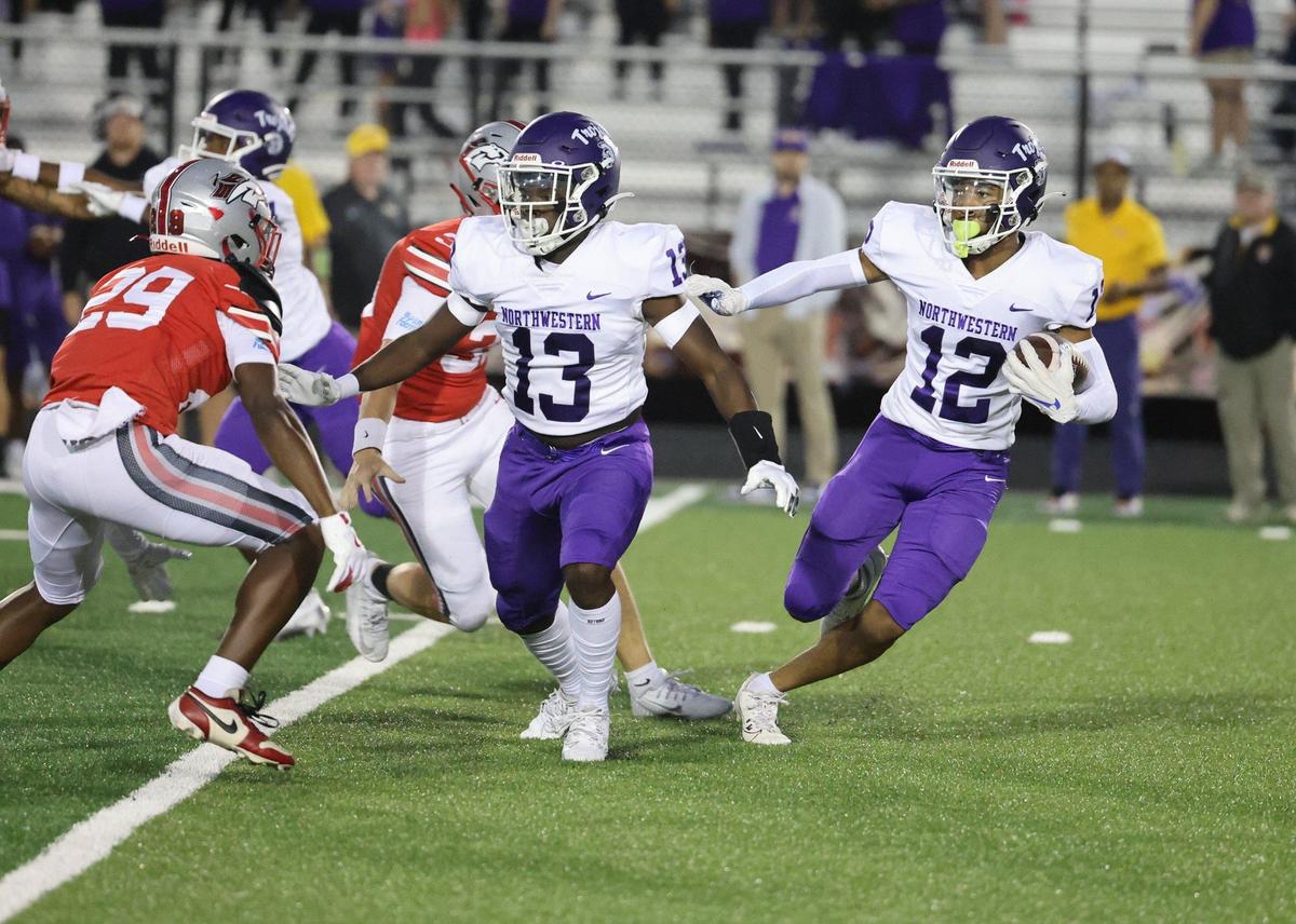 Northwestern’s C.J. Broughton (13) tries to keep South Pointe’s Zahyden Ratliff (29) away from Jonathan Spurgeon (12).