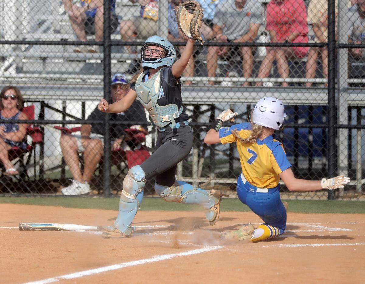 Fort Mill’s Maddie Drerup slides into home plate as Dorman’s Emma Bright waits for the ball.