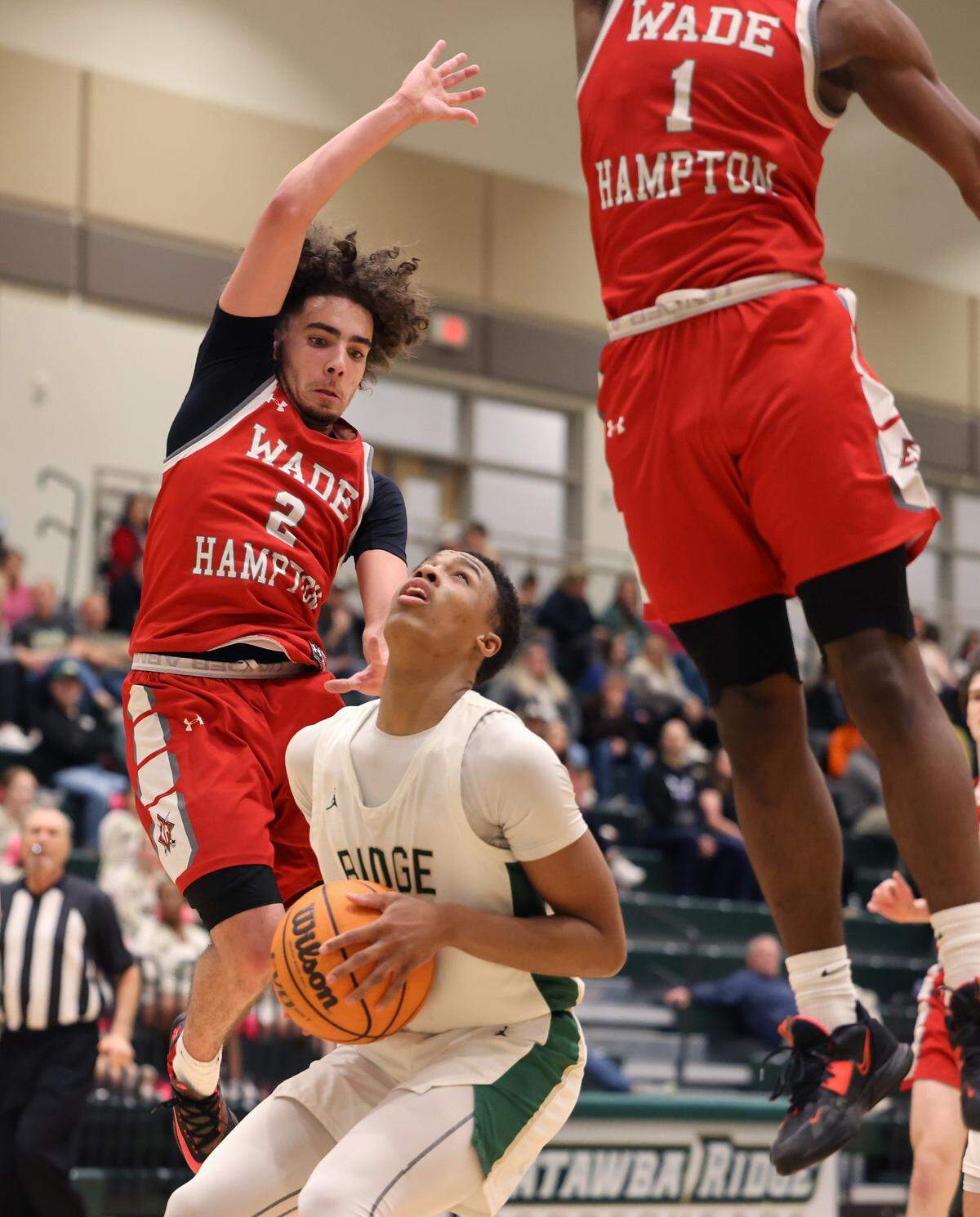 Catawba Ridge’s Lance Barnes looks to the basket against Wade Hampton’s K.J. Banks (2) and K.D. Owens (1)