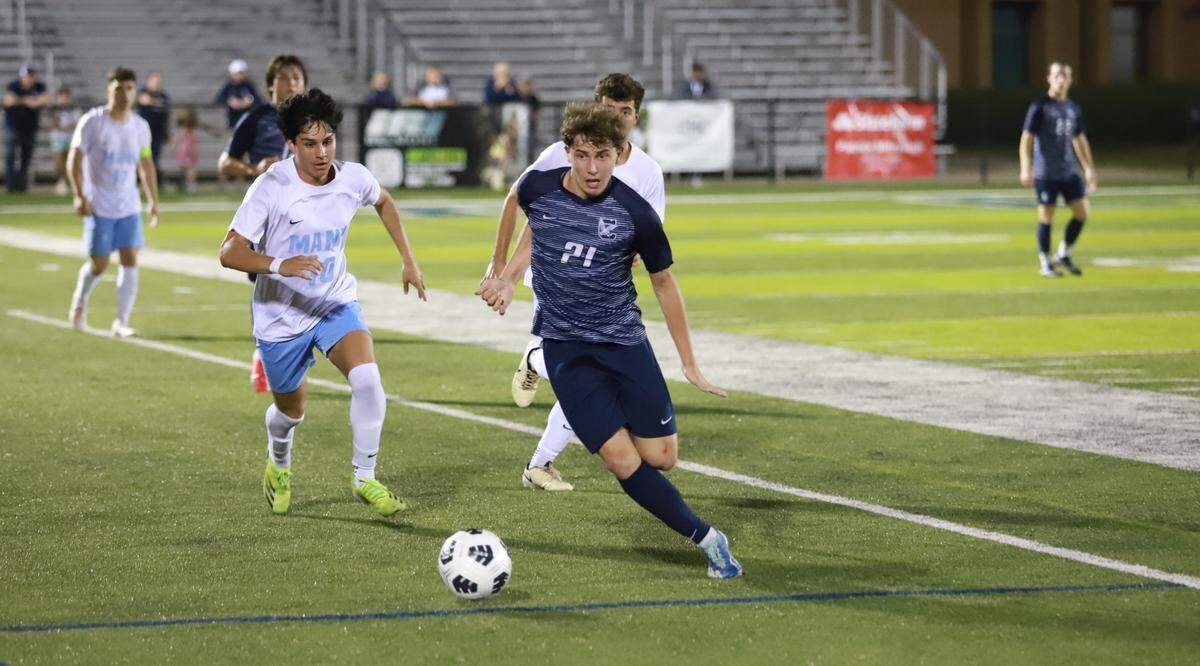 Sophomore Gavin Pierce (21, dark blue) got the scoring started for Clover in its 3-2 loss to J.L. Mann in the 2024 5A Boys Soccer Upper State Semifinals on May 3.