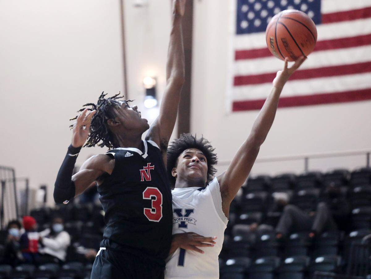 York Prep’s D.J. Barksdale puts up the shot against Northside Christian’s Wesley Tubs III Thursday at the Battle at the Rock High School Basketball Showcase. The event was held at the Rock Hill Sports and Event Center.