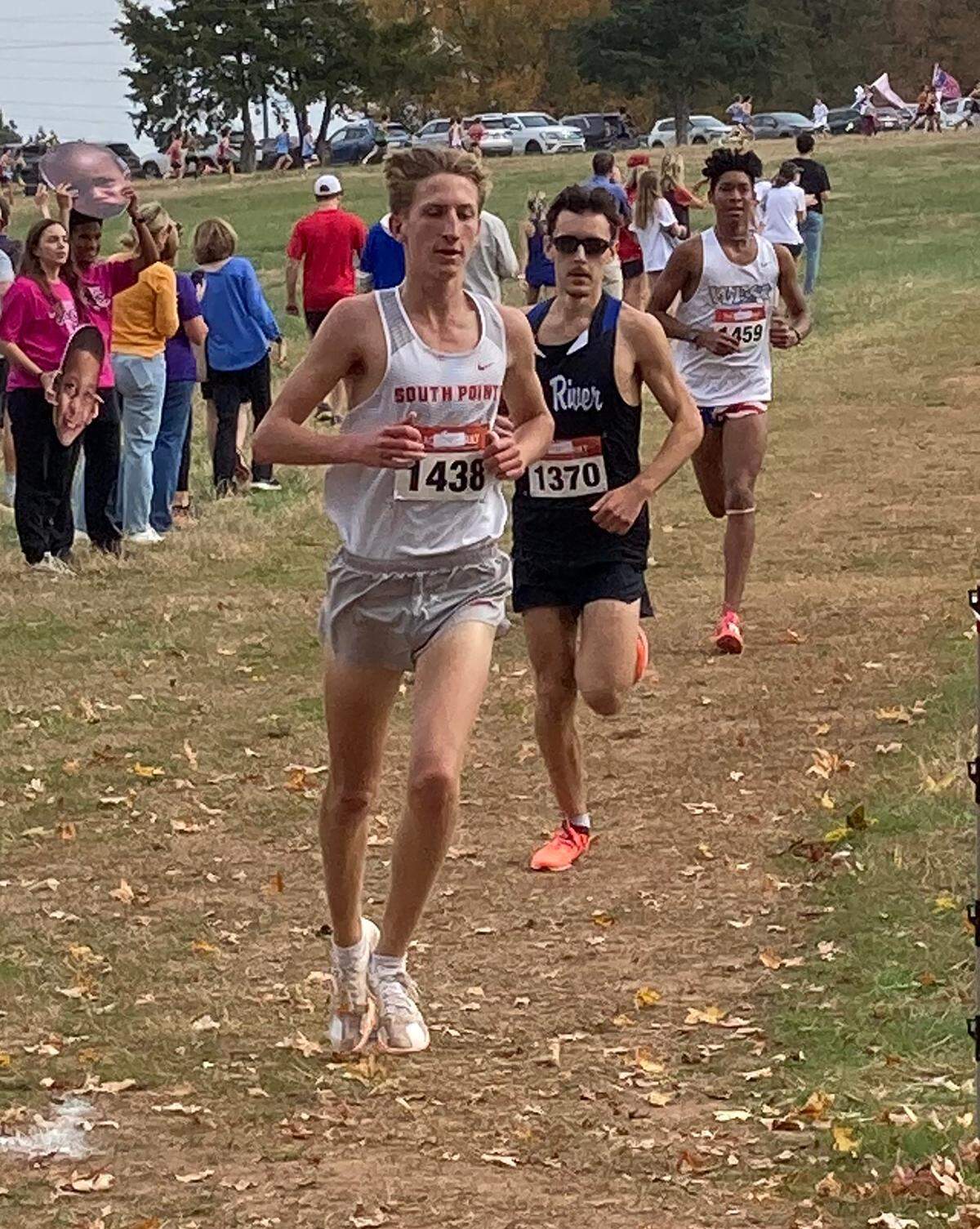 South Pointe cross-country runner, left, competes at a race on Nov. 10, where he won the state championship.