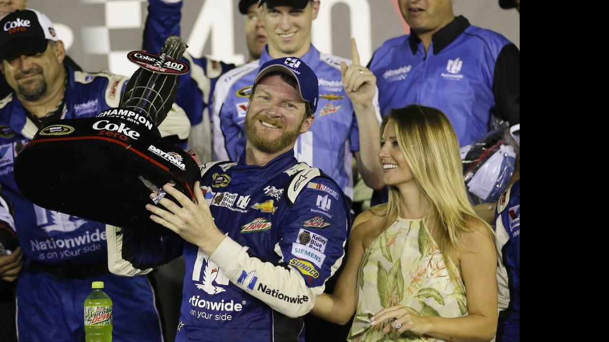 
Dale Earnhardt Jr. and fiance Amy Reimann, right, celebrate after Earnhardt won the NASCAR Sprint Cup series Coke Zero 400 at Daytona International Speedway early Monday morning. 
