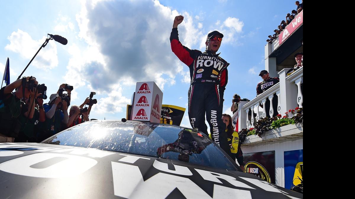
Martin Truex Jr. celebrates in Victory Lane after winning the NASCAR Sprint Cup Series Axalta 'We Paint Winners' 400 at Pocono Raceway on Sunday, June 7, 2015 in Long Pond, Pa.
