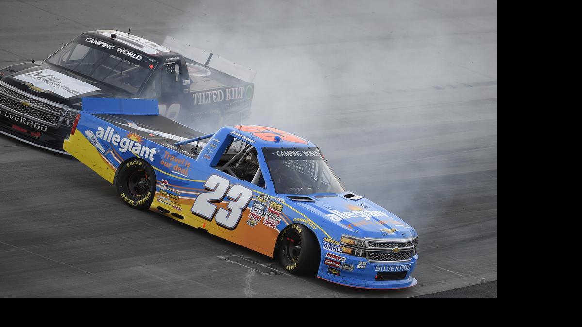 
Spencer Gallagher (23) gets sideways next to Korbin Forrister, top, during a NASCAR Trucks series auto race, Friday, May 29, 2015, at Dover International Speedway in Dover, Del.
