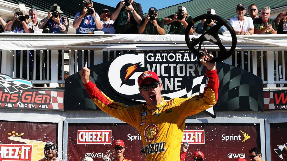 
Joey Logano celebrates in victory lane after winning the NASCAR Sprint Cup Series Cheez-It 355 at the Glen at Watkins Glen International on Sunday, Aug. 9, 2015 in Watkins Glen, N.Y.
