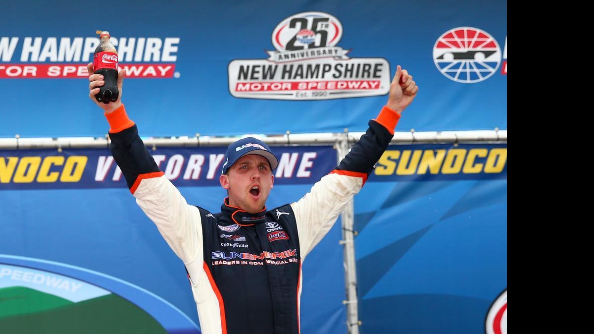 
Denny Hamlin celebrates in Victory Lane after winning the NASCAR XFINITY Series Lakes Region 200 at New Hampshire Motor Speedway on Saturday, July 18, 2015 in Loudon, N.H.
