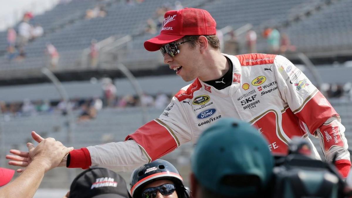 
Brad Keselowski is congratulated by crew members after winning the pole for Sunday’s NASCAR Sprint Cup auto race at Darlington Raceway in Darlington, S.C., Saturday. 
