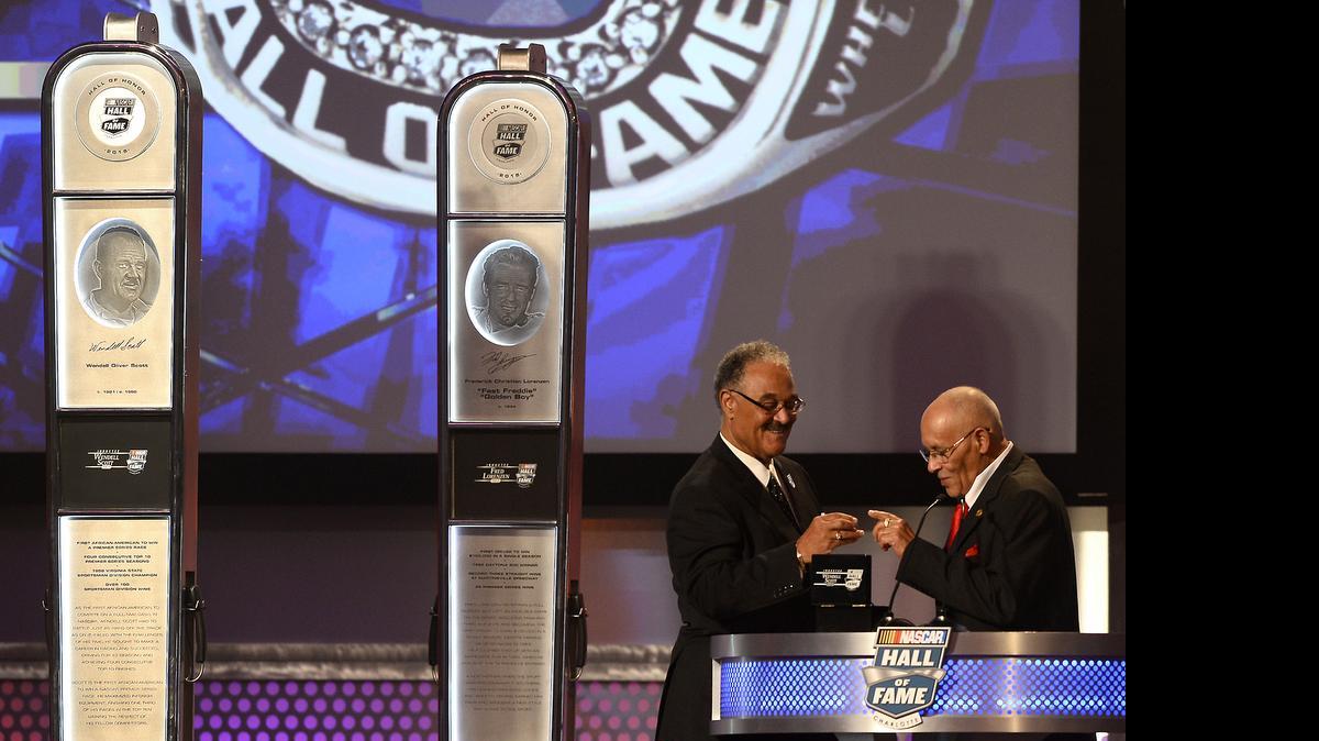 
Former NASCAR driver Wendell Scott's son Franklin Scott hands his father's Hall of Fame ring to his brother, Wendell Scott Jr., during the NASCAR Hall of Fame Class of 2015 Induction Ceremony on Jan. 30, 2015. Mary Scott was unable to attend the ceremony.
