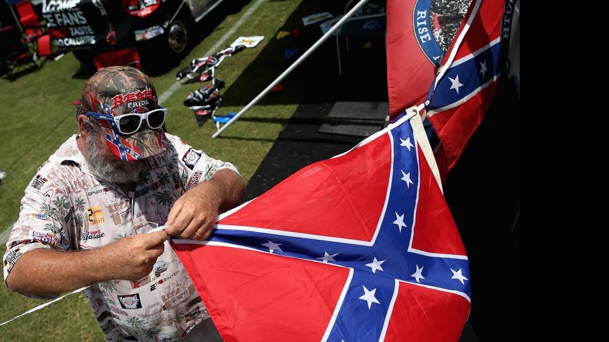 
A fan holds a Confederate flag during practice for the NASCAR XFINITY Series Subway Firecracker 250 at Daytona International Speedway on July 3, 2015 in Daytona Beach, Fla.
