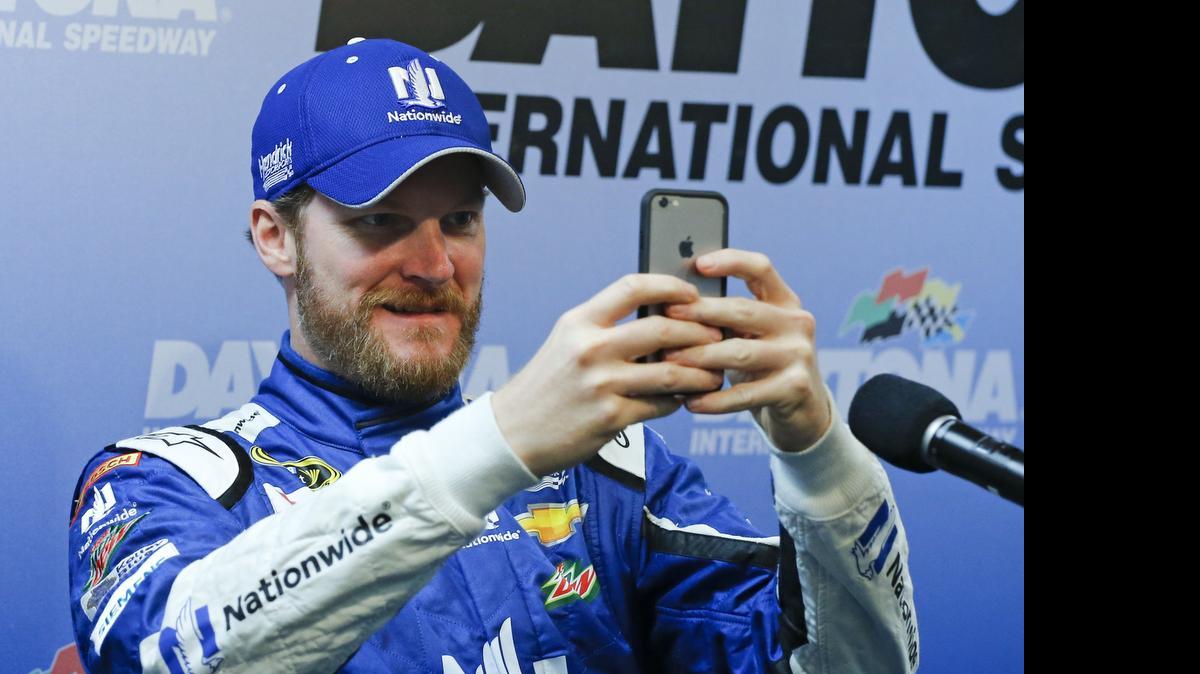 Dale Earnhardt Jr. takes photos of the media during a news conference after qualifying at Daytona on Saturday.