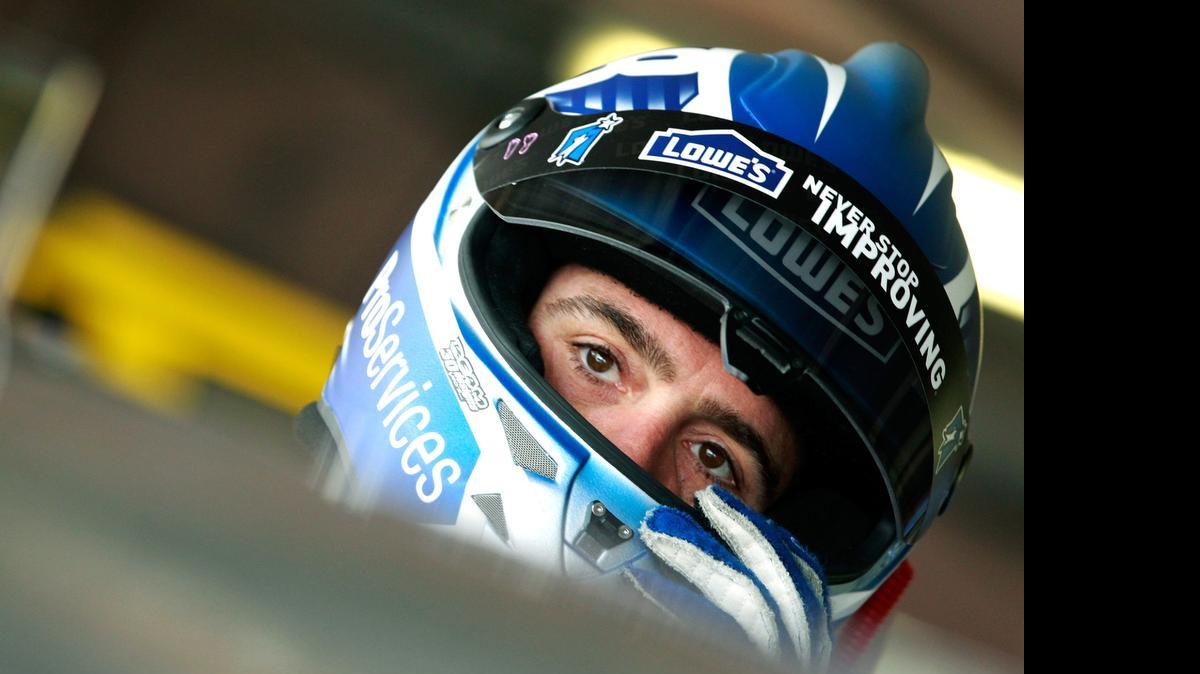 
Jimmie Johnson climbs into his car in the garage area during practice for the NASCAR Sprint Cup Series FedEx 400 Benefiting Autism Speaks at Dover International Speedway on Friday, May 29, 2015 in Dover, Del. 
