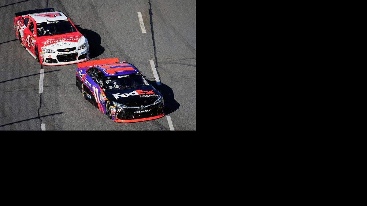 
Denny Hamlin, driver of the #11 FedEx Express Toyota, leads Kevin Harvick, driver of the #4 Budweiser/Jimmy John's Chevrolet, during the NASCAR Sprint Cup Series STP 500 at Martinsville Speedway on March 29, 2015 in Martinsville, Va.
