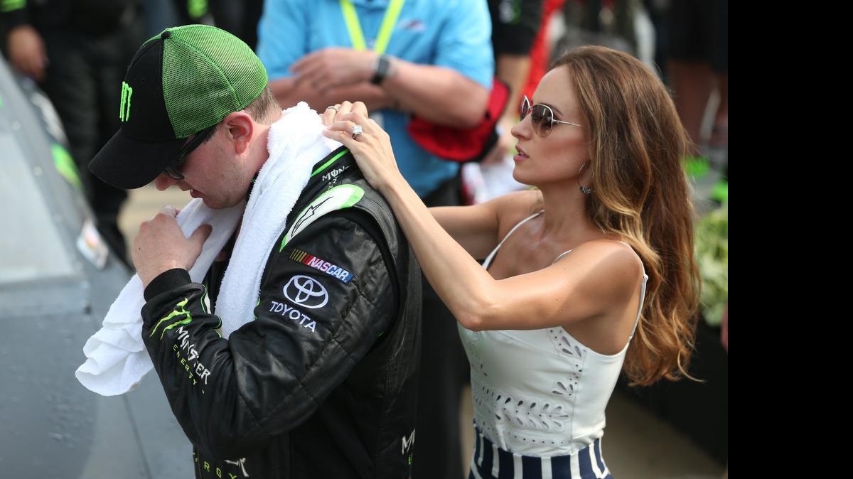 
Kyle Busch, is assisted by his wife Samantha as he tries to cool off following the NASCAR XFINITY Series Lilly Diabetes 250 at Indianapolis Motor Speedway on July 25, 2015 in Indianapolis.
