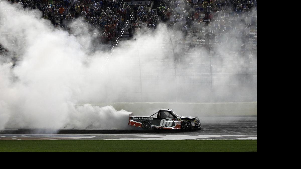 
Kasey Kahne (00) does a burnout after winning the NASCAR Trucks series North Carolina Education Lottery auto race at Charlotte Motor Speedway in Concord, Friday, May 15, 2015. 
