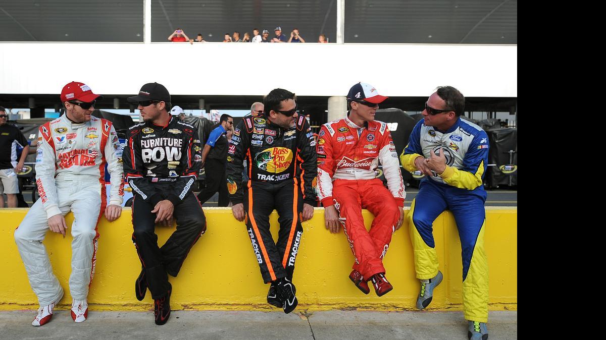 
NASCAR Sprint Cup Series drivers Dale Earnhardt Jr. (88), Martin Truex (78), Tony Stewart (14) , Kevin Harvick (4) and Dave Blaney (77) talk along pit road prior to qualifying for the Coca-Cola 600 on May 22, 2014 at Charlotte Motor Speedway.
