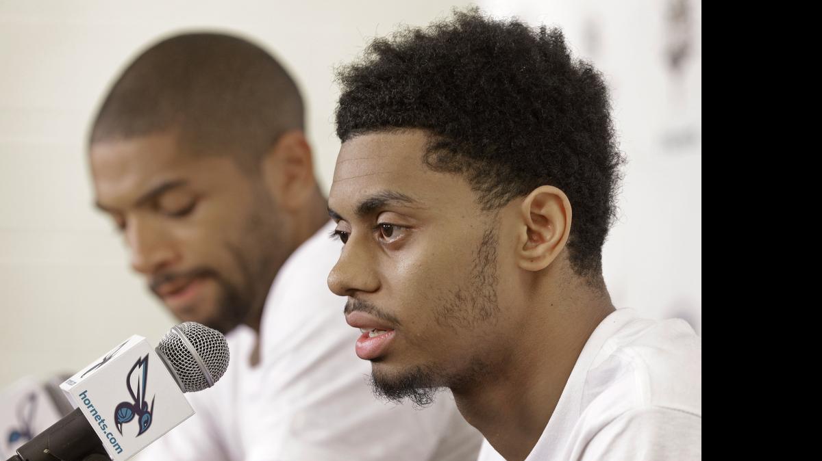 
Newly acquired player Jeremy Lamb, right, answers a question as Nicolas Batum, left, listens during the Hornets’ introductory news conference Friday at Time Warner Cable Arena.
