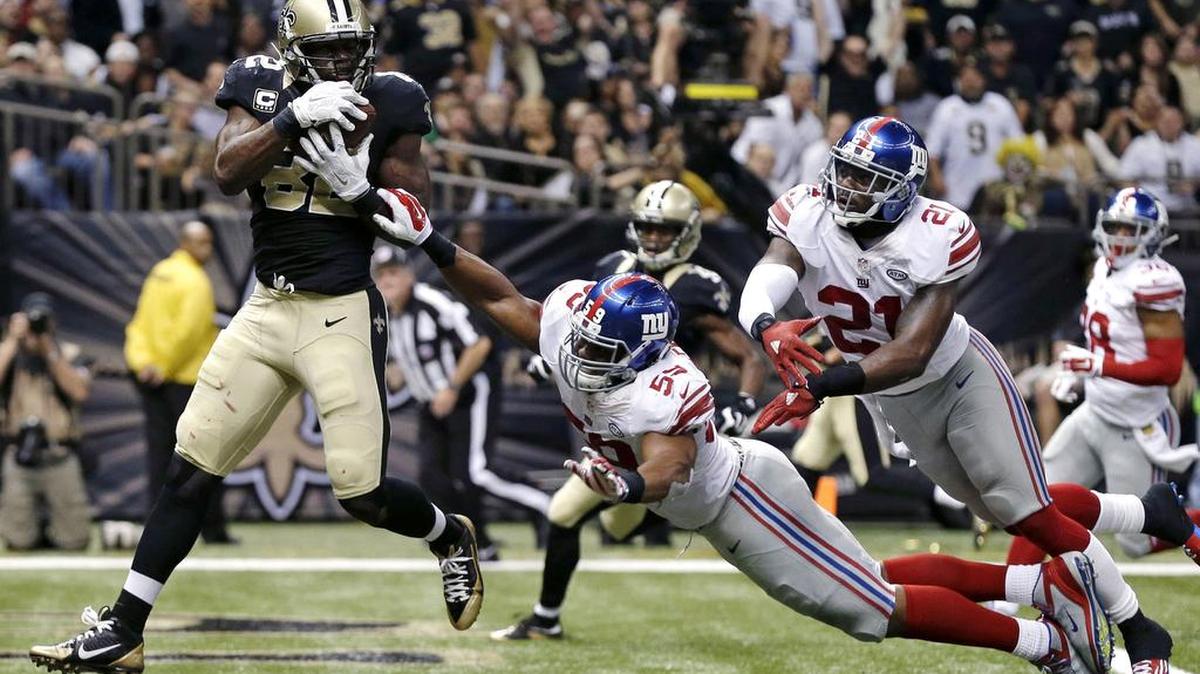 The son of a preacher, New Orleans Saints tight end Benjamin Watson, seen with a Nov. 1 touchdown catch against the Giants, has made a name for himself off the field with his charitable contributions to his community.