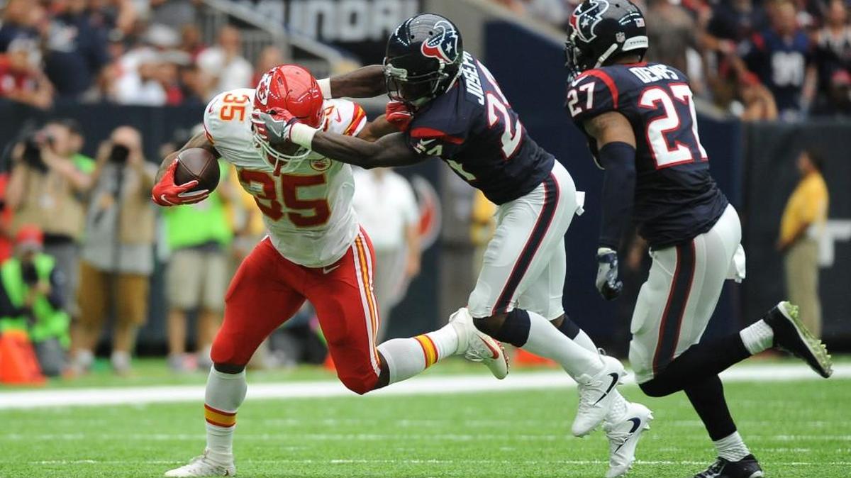 Kansas City Chiefs running back Charcandrick West (35) is tackled by Houston Texans cornerback Johnathan Joseph (24) during the first half of an NFL football game Sunday, Sept. 18, 2016, in Houston.