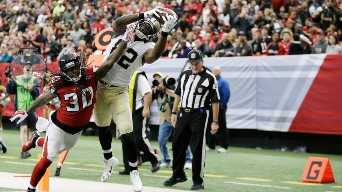 New Orleans Saints tight end Benjamin Watson (82) makes a touchdown catch in the end zone against Atlanta Falcons free safety Charles Godfrey (30) during the first half of an NFL football game, Sunday, Jan. 3, 2016, in Atlanta.