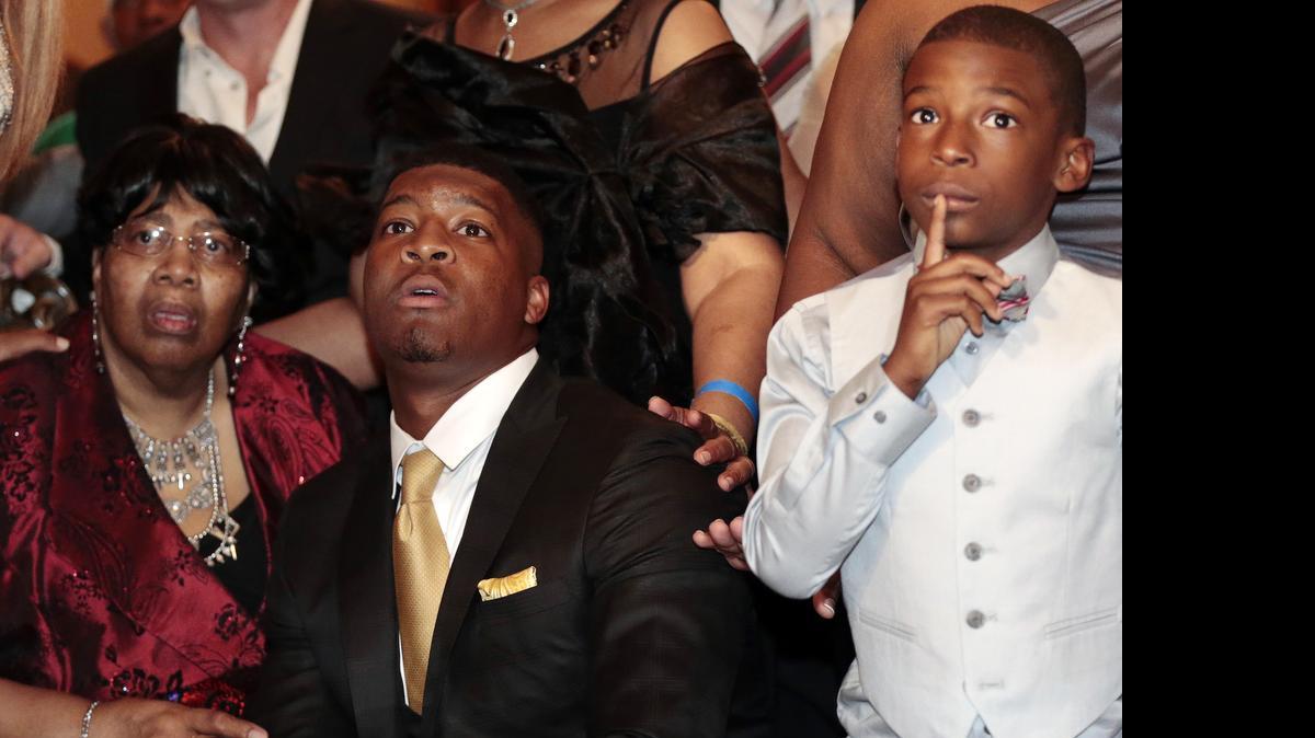
Myrtle Winston, grandmother, left, Jameis Winston, and little brother Jonah Winston watch as they make the announcement for the selection of the 2015 NFL Draft, Thursday, April 30, 2015, in Bessemer, Ala. 
