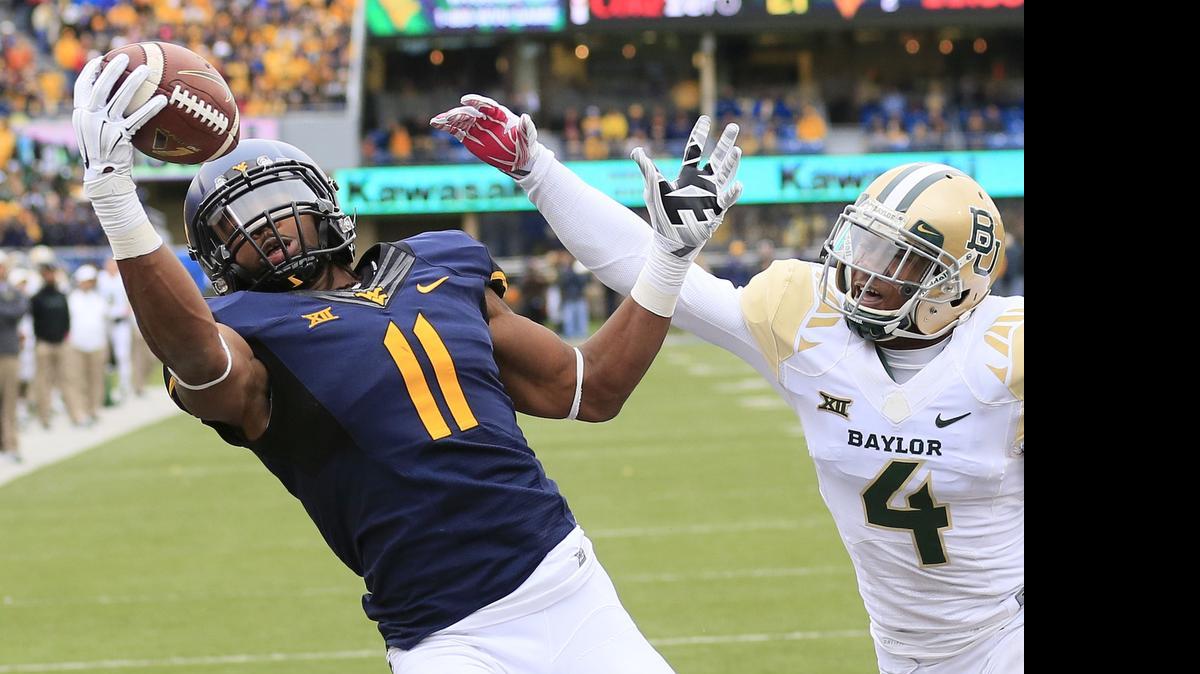 
West Virginia’s Kevin White (11) is a big, explosive wide receiver who had 109 catches as a senior. 
