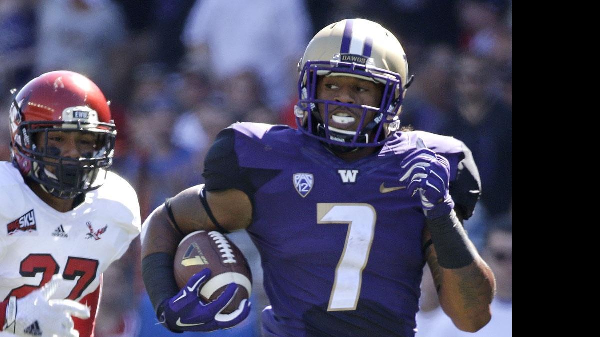 
In this Sept. 6, 2014, file photo, Washington linebacker Shaq Thompson (7) runs for a 57-yard touchdown against Eastern Washington.
