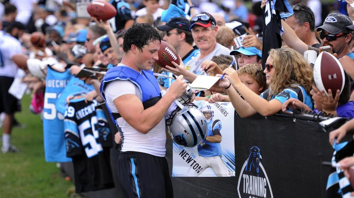 
Carolina Panthers linebacker Luke Kuechly (59) signs autographs for fans after practice on Sunday at Wofford College in Spartanburg. Kuechly is awaiting a big contract extension, which could happen before the season. 
