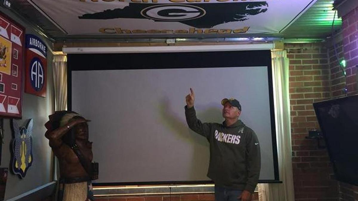 Mike Dobs put the Packers banner provided by the Panthers on the ceiling of his “man room.”