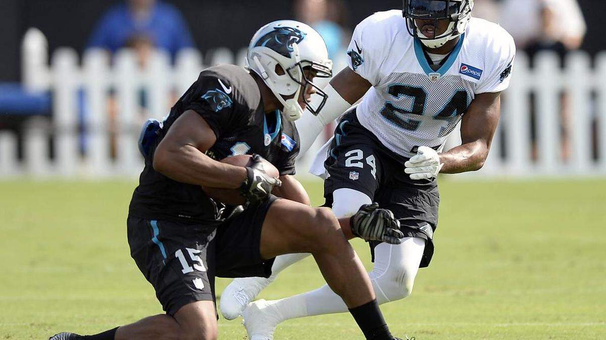 
Carolina Panthers wide receiver Kelvin Benjamin (13) makes a reception in front of Josh Norman (24) during morning practice during training camp at Wofford College in Spartanburg on Tuesday. Benjamin and the first-team offense are still having issues in the red zone. 
