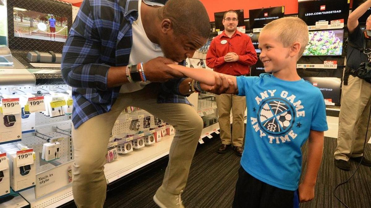 Cam Newton clowns around as he helps Target shopper Miller Shelton, 7, of Fort Mill shop at Target Thursday.