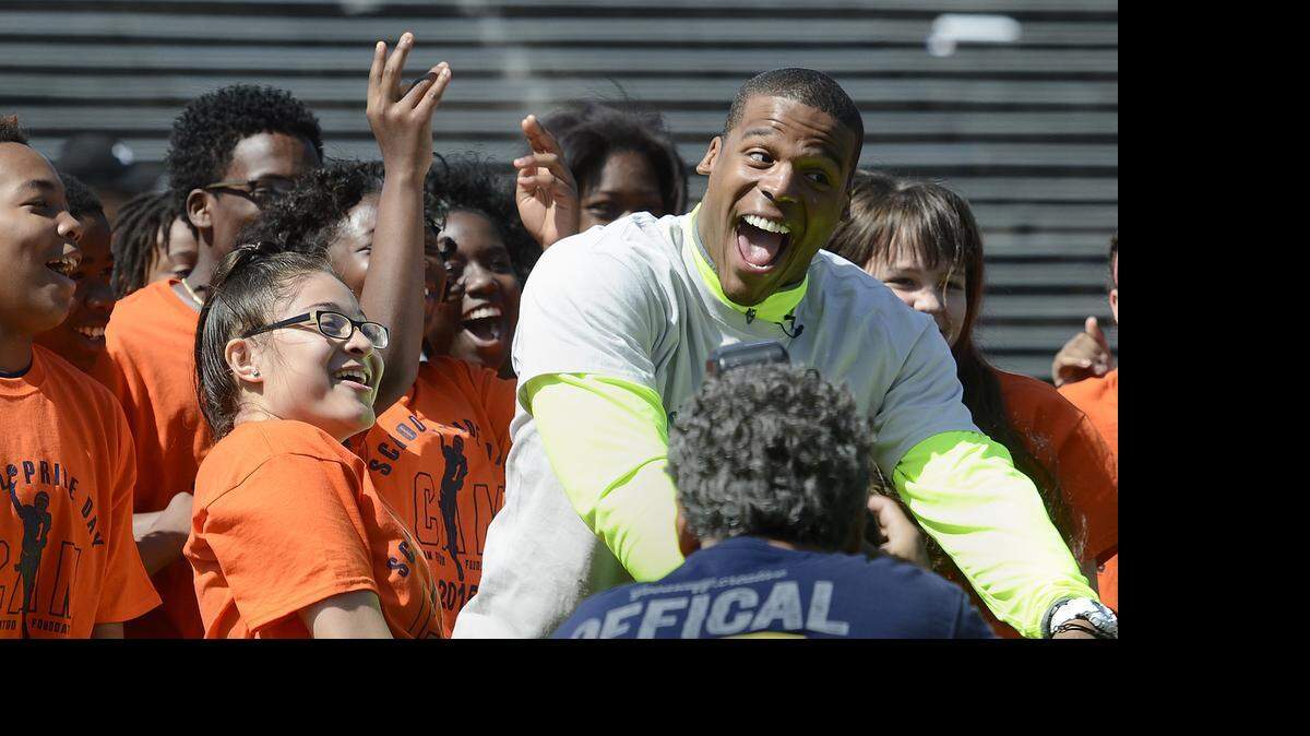 
Panthers quarterback Cam Newton dances with middle- school students Friday at Memorial Stadium. About 800 students from more than 40 middle schools and academies attended Cam Newton's School Pride Day. 
