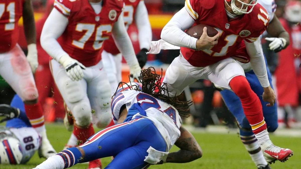 Chiefs quarterback Alex Smith (11) tries to jump over a tackle by Bills cornerback Stephon Gilmore (24) during the second half Sunday.