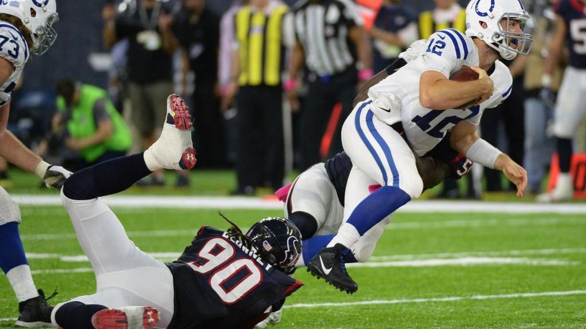 Indianapolis Colts quarterback Andrew Luck (12) is sacked by Houston Texans outside linebacker Whitney Mercilus (59) and Jadeveon Clowney (90) during the second half of an NFL football game Sunday, October, 16, 2016, in Houston.