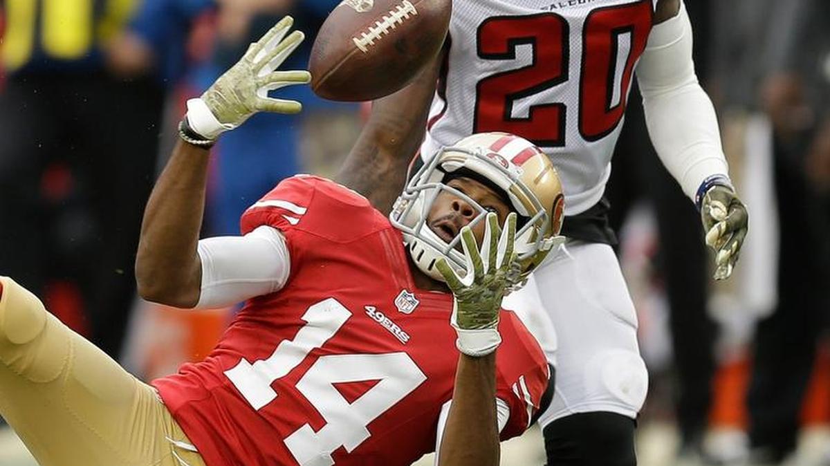 San Francisco 49ers wide receiver Jerome Simpson (14) cannot catch a pass which was intercepted by Atlanta Falcons defensive back Phillip Adams (20) during the second half of an NFL football game in Santa Clara, Calif., Sunday, Nov. 8, 2015.