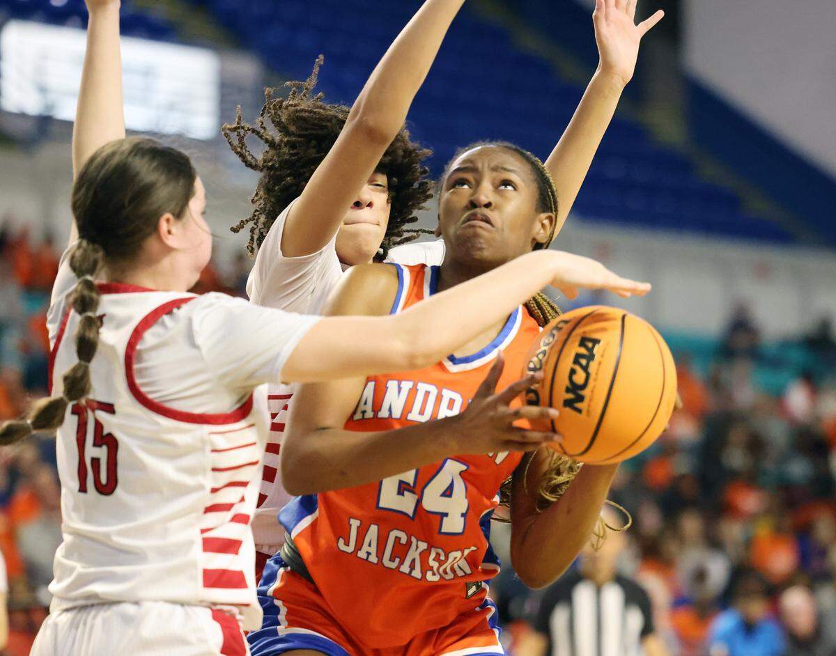 Andrew Jackson’s Tamia Watkins heads to the basket against Landrum’s Emalynn Bright, left, and Kennedy Gardner-Speech Friday in Florence.