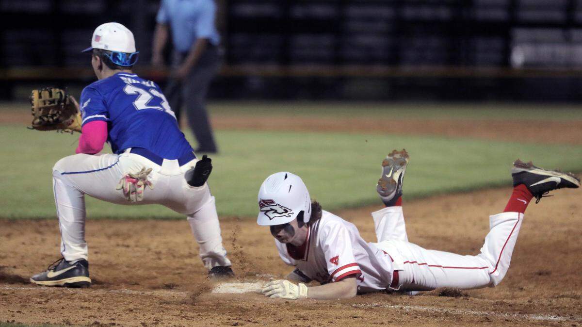 South Pointe’s Dalton Bucy slides back into first base as Indian Land’s Logan Sulli waits for the ball.