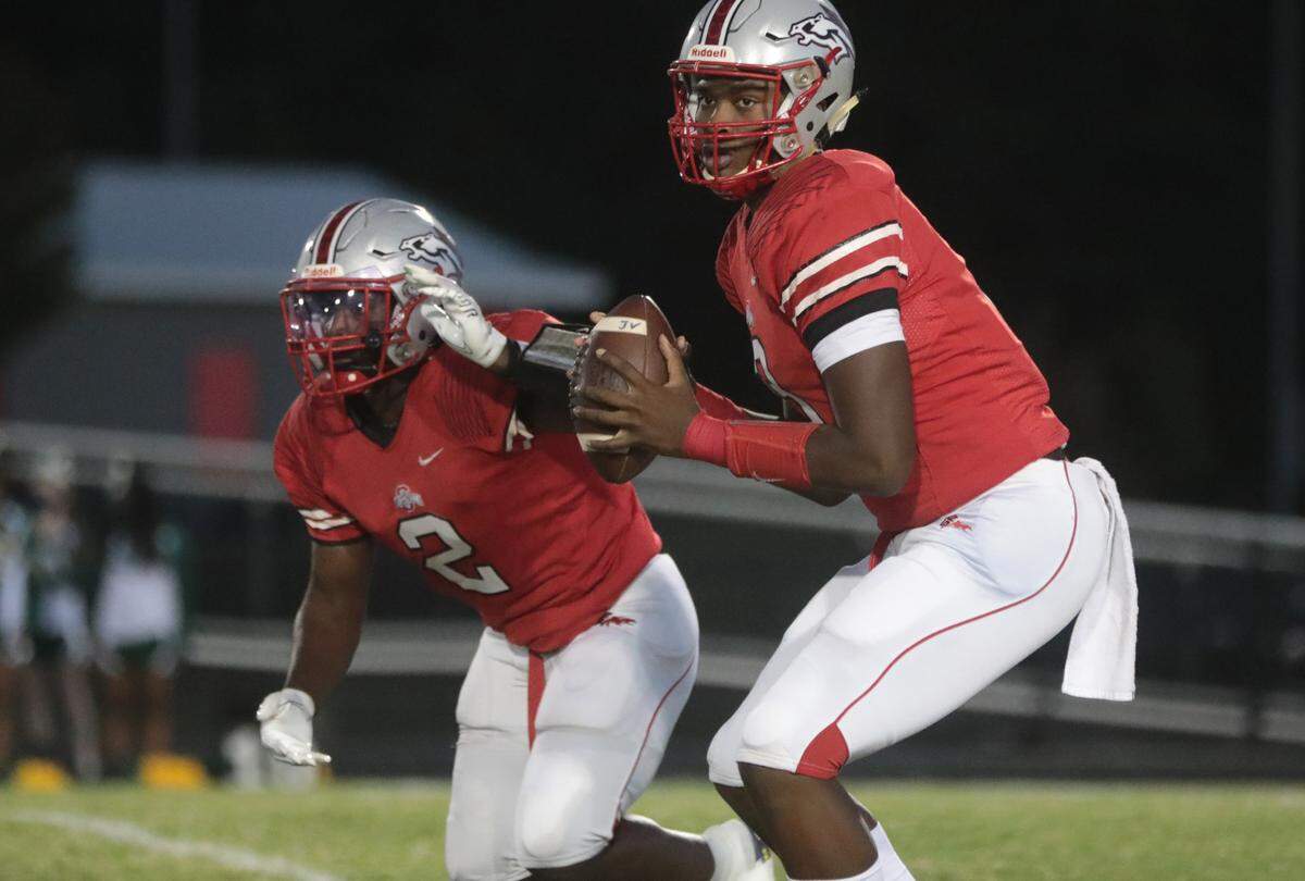 South Pointe’s Zaveion Mccrorey looks for an opening as Caleb Sims runs by.