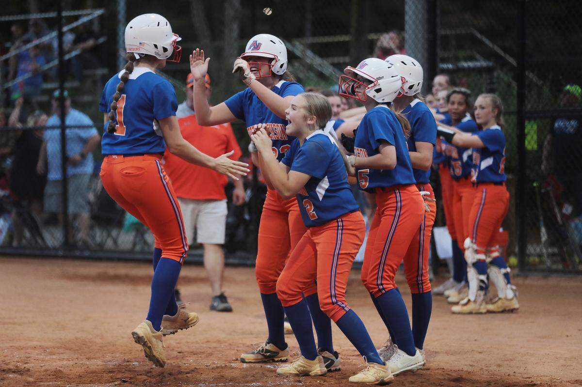 Members of the Andrew Jackson softball team celebrate after teammate Caroline Wrenn scores at Cherry Park in the 2021 Class 2A state championship.