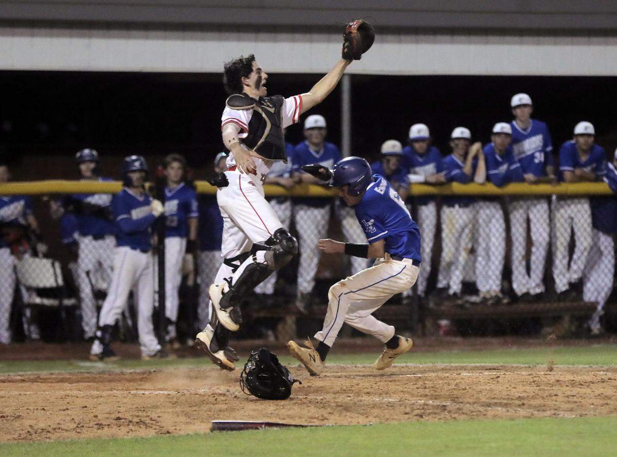 Indian Land’s Drew Endres heads for home plate as South Pointe catcher Kyle Murphy leaps for the ball.
