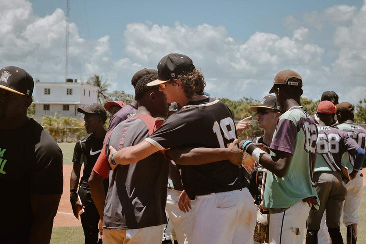 Mathieu Curtis (right) meets with his opponents after a game in the Domincan Republic on its annual mission trip.