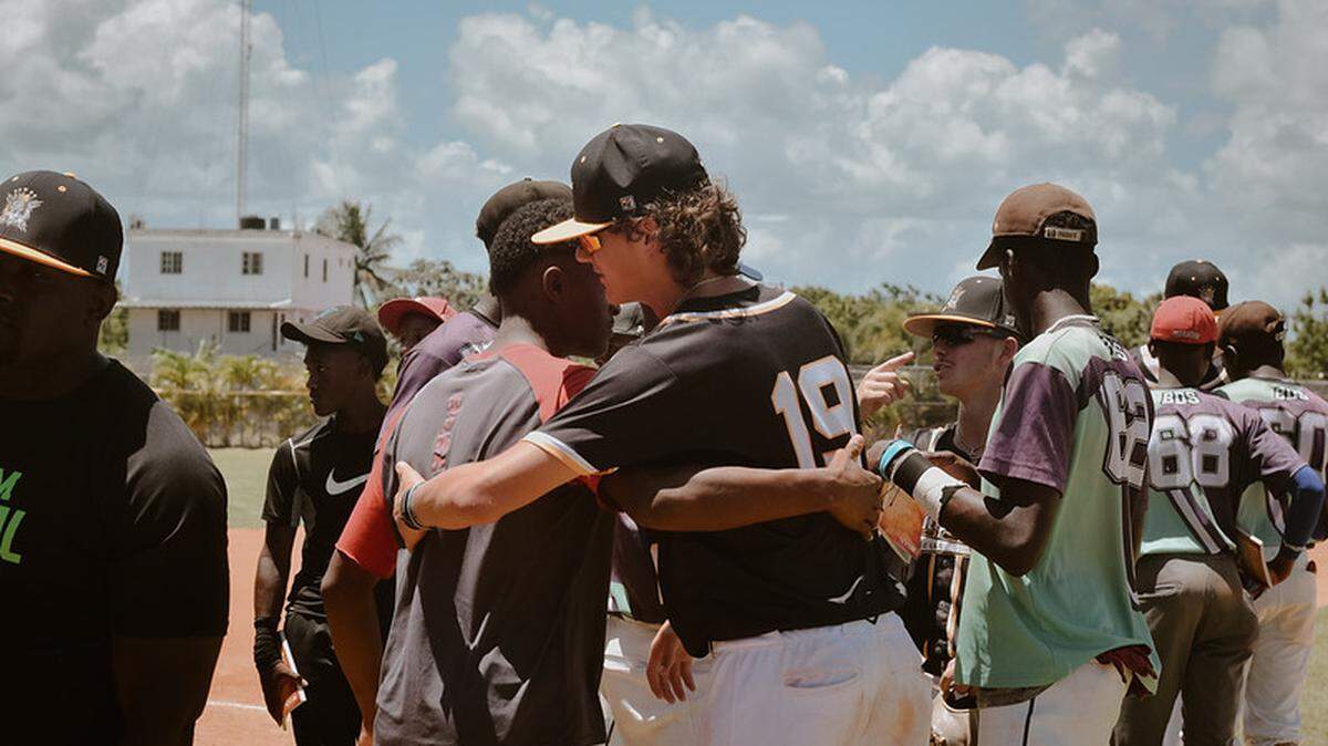 Mathieu Curtis (right) meets with his opponents after a game in the Domincan Republic on its annual mission trip in July 2022.