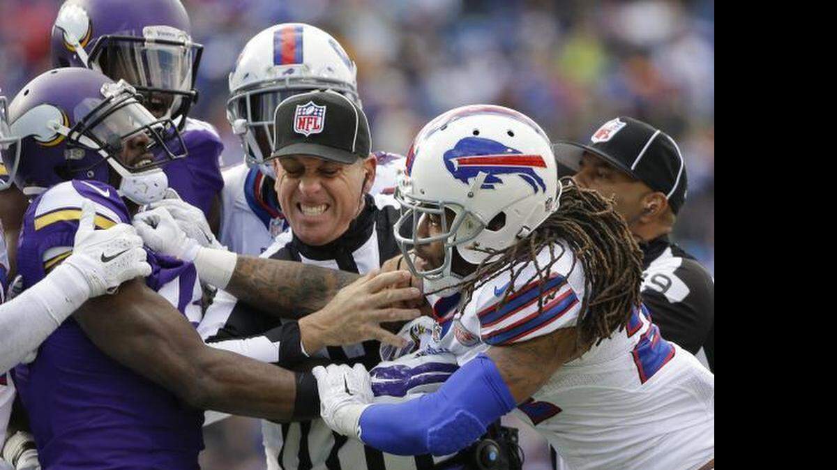 Line judge John Hussey separates Minnesota Vikings' Greg Jennings (15) and Buffalo Bills' Stephon Gilmore (24) during the second half of an NFL football game, Sunday, Oct. 19, 2014, in Orchard Park, N.Y. 
