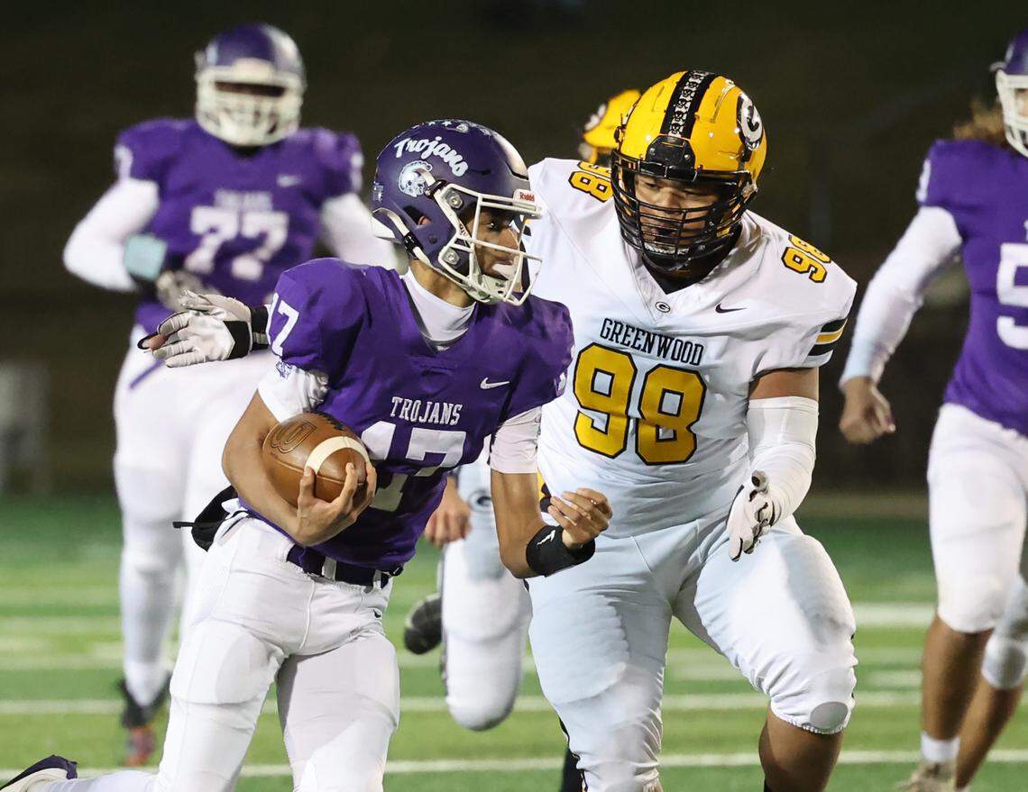Northwestern’s Xavier Means (17) carries the ball against Greenwood’s Korrell Parks Friday in Rock Hill.